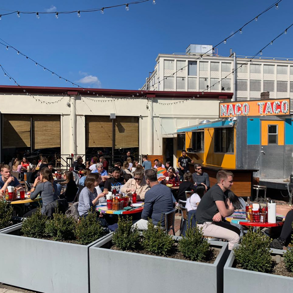 The sun shines on taco lovers dining on the Naco Taco patio in Boston.