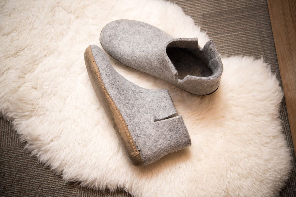 A white fluffy rug with slippers