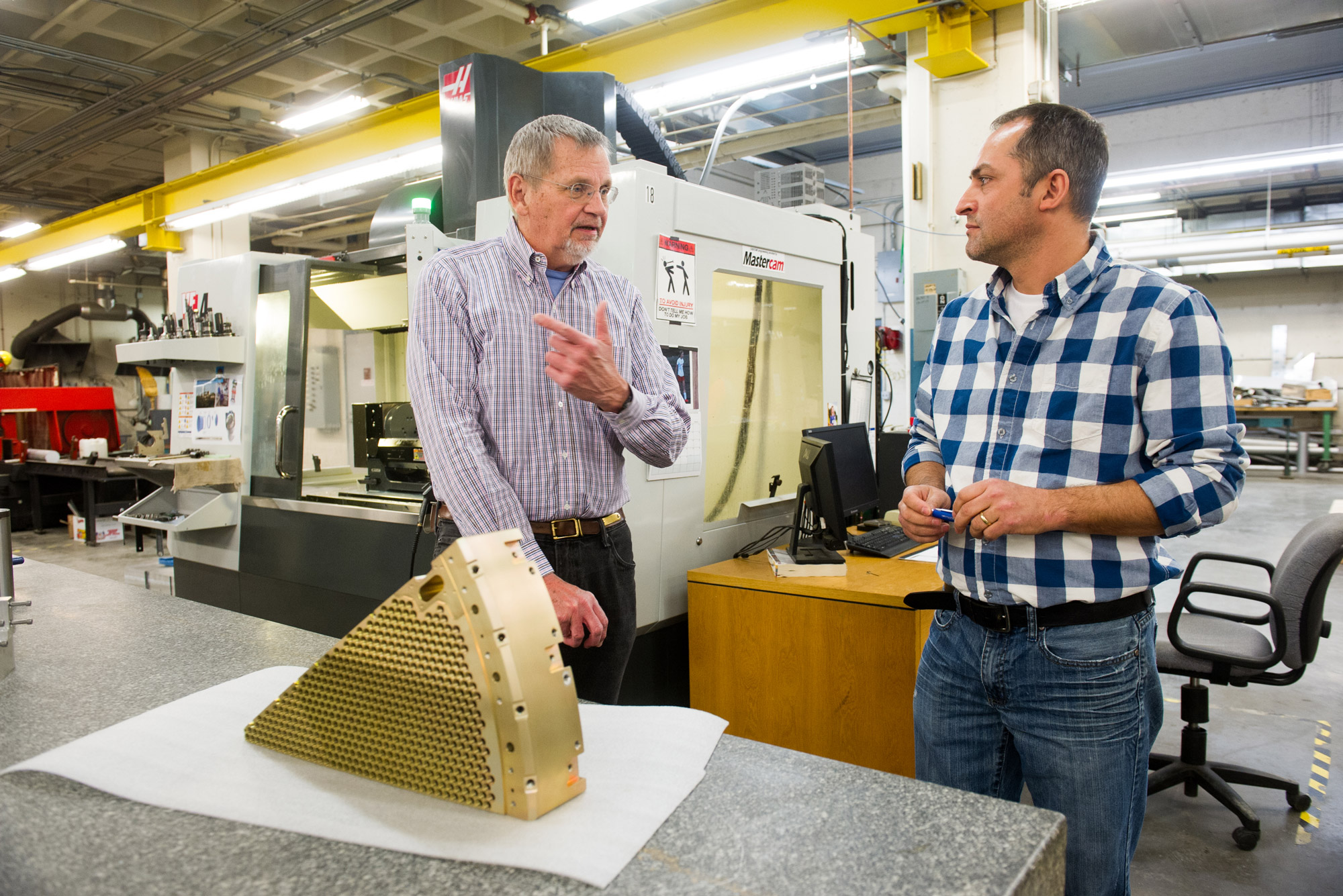 Professor Steven Ahlen and Sif Operations Manager Heitor Maturate with Ahlen's component for Dark Energy Spectroscopic Instrument (DESI)