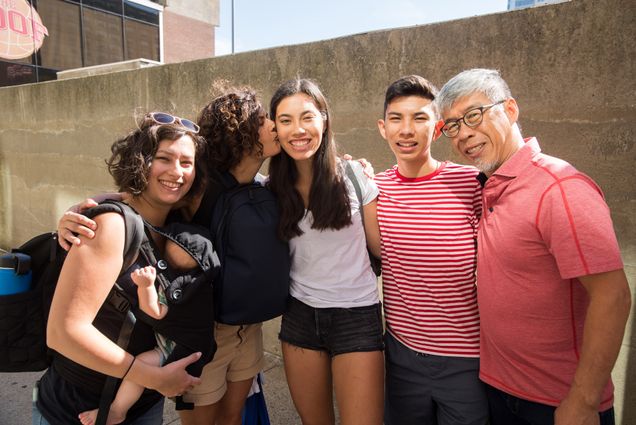 the Khaw family hugs during move-in