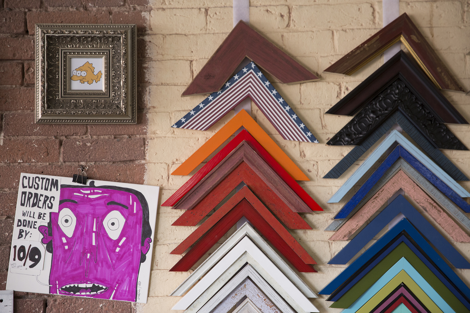 Photo: Frame samples hanging on the wall at Framer's Workshop.