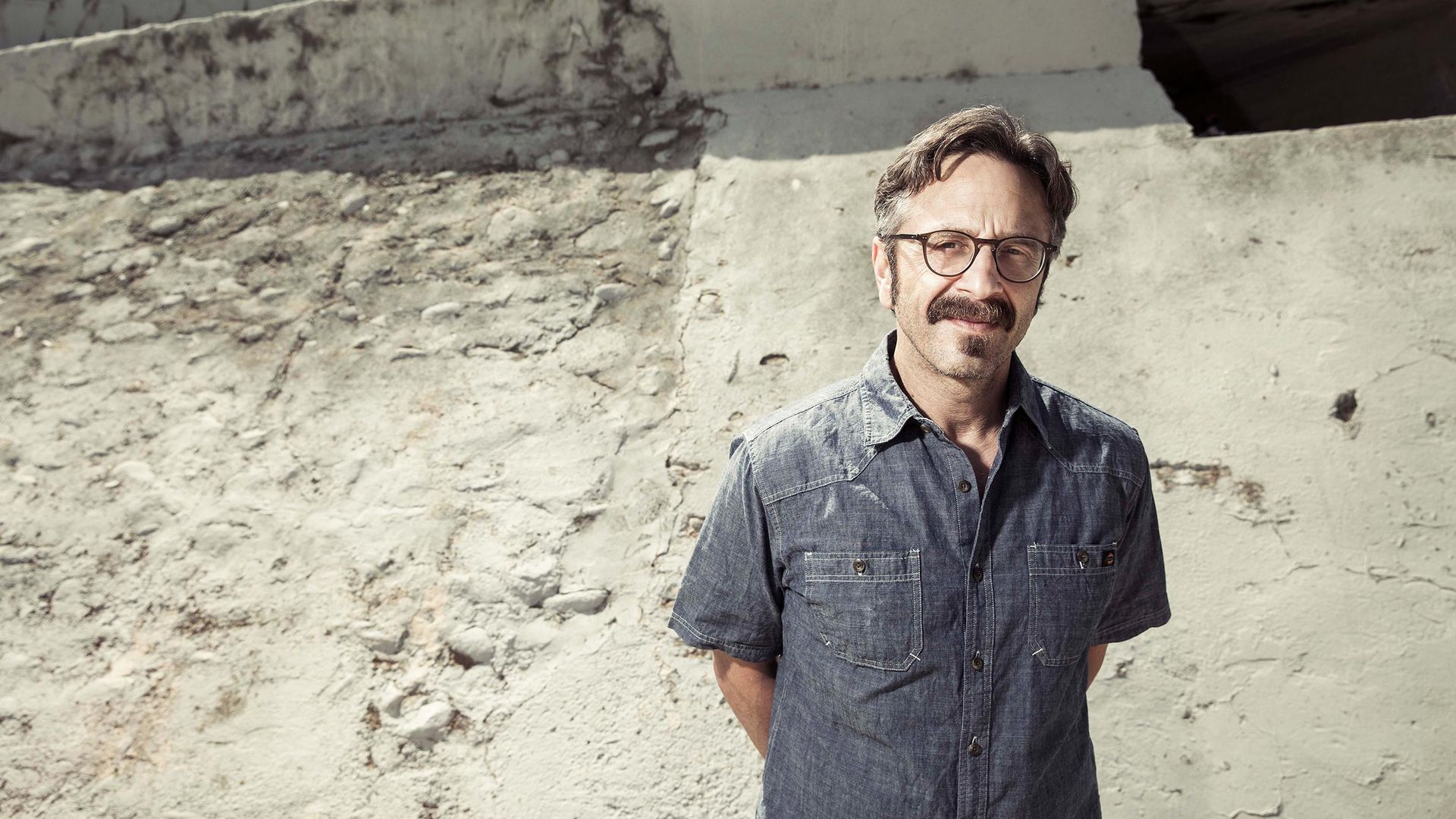Portrait of Marc Maron standing in a dry waterway