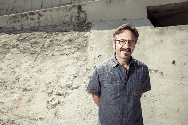 Portrait of Marc Maron standing in a dry waterway