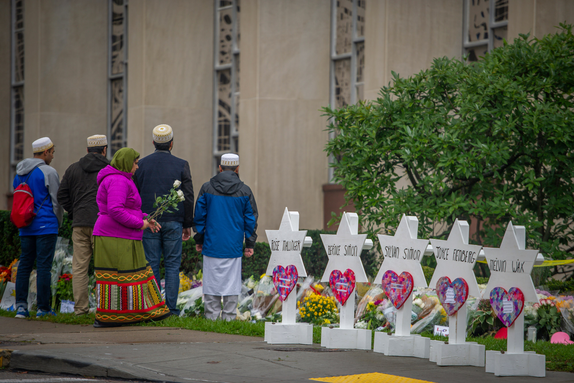 Samina Mohamedali prepares to place flowers on a memorial in front of the Tree of Life Congregation