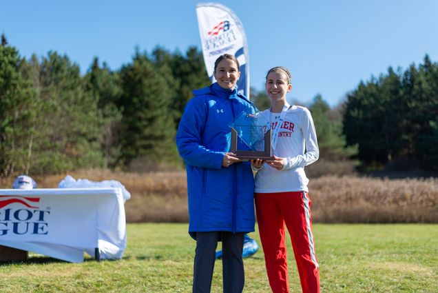 Abigail Gugel holds her award while standing next to Emily Parkins, Director for Championships and Sport Management for the Patriot League.
