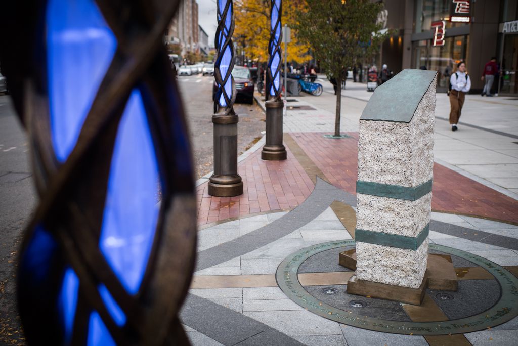 The Boston marathon marker surrounded by glowing spikes at dusk
