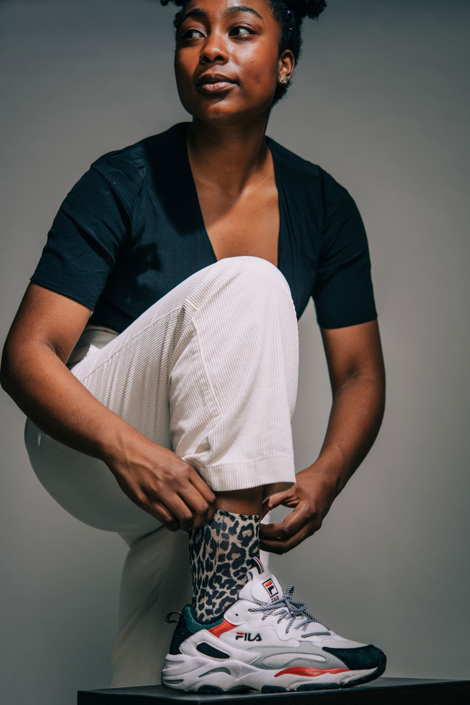 Asjha Malcolm (CFA’23) shows off mesh cheetah socks she got from ASOS