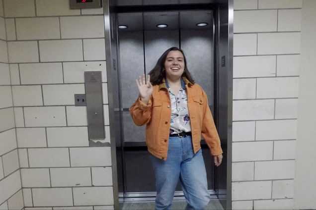 Temma Pelletier waves to the camera as she exits an elevator.