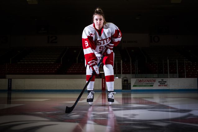 Abby Cook poses for a photo on the ice while wearing her hockey uniform