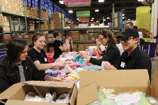 Volunteers sort items for Cradle to Crayons