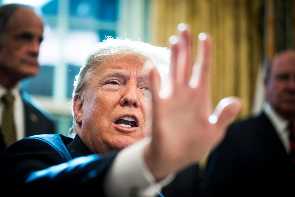 President trump holds his hand up blocking the frame