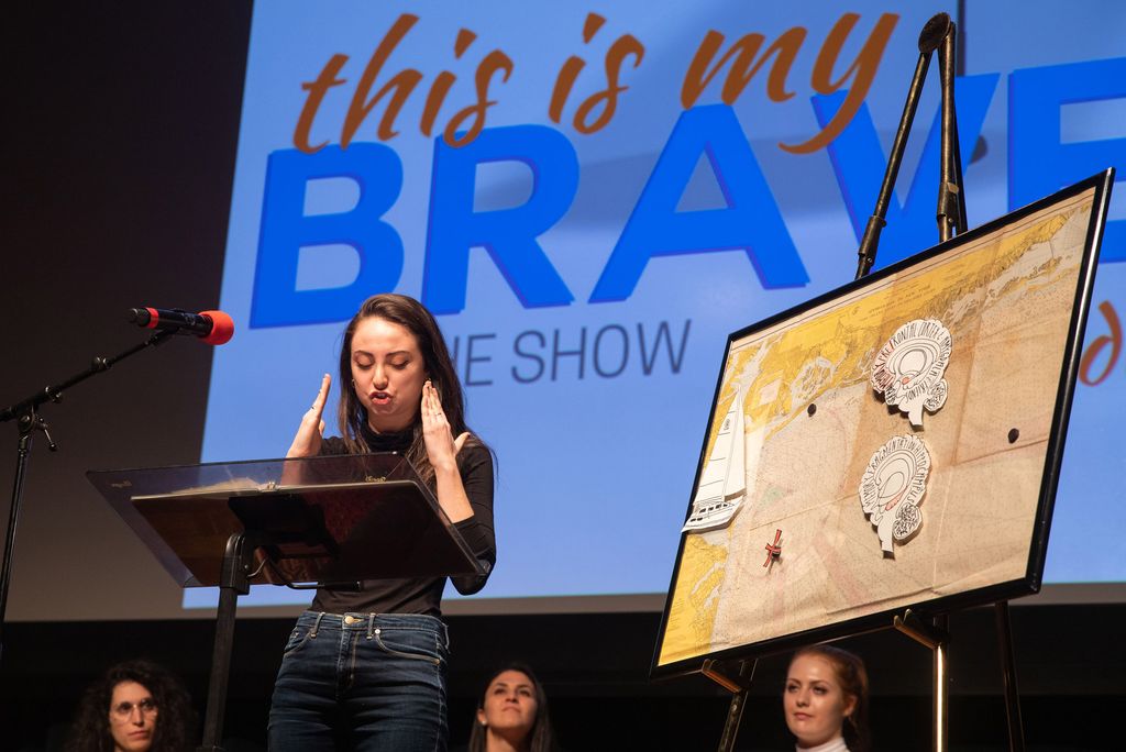 A photo of Sarah Horowitz (GRS) telling her story of recovering from PTSD during the "This is My Brave," storytelling performance at the Tsai Performance Center.