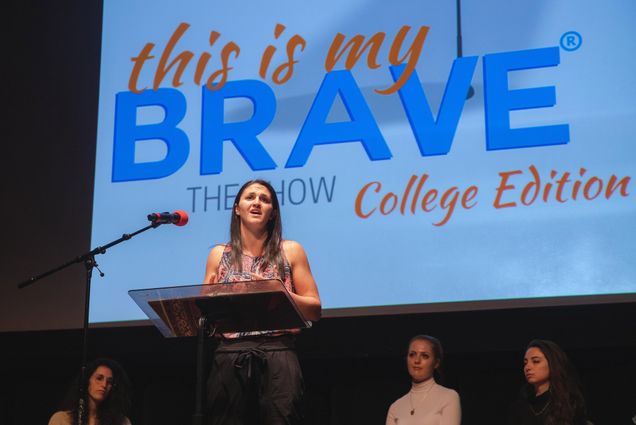 A photo of Ali Gold (SAR'20) sharing her experience of studying and struggling with mental health issues during the "This is My Brave," storytelling performance at the Tsai Performance Center