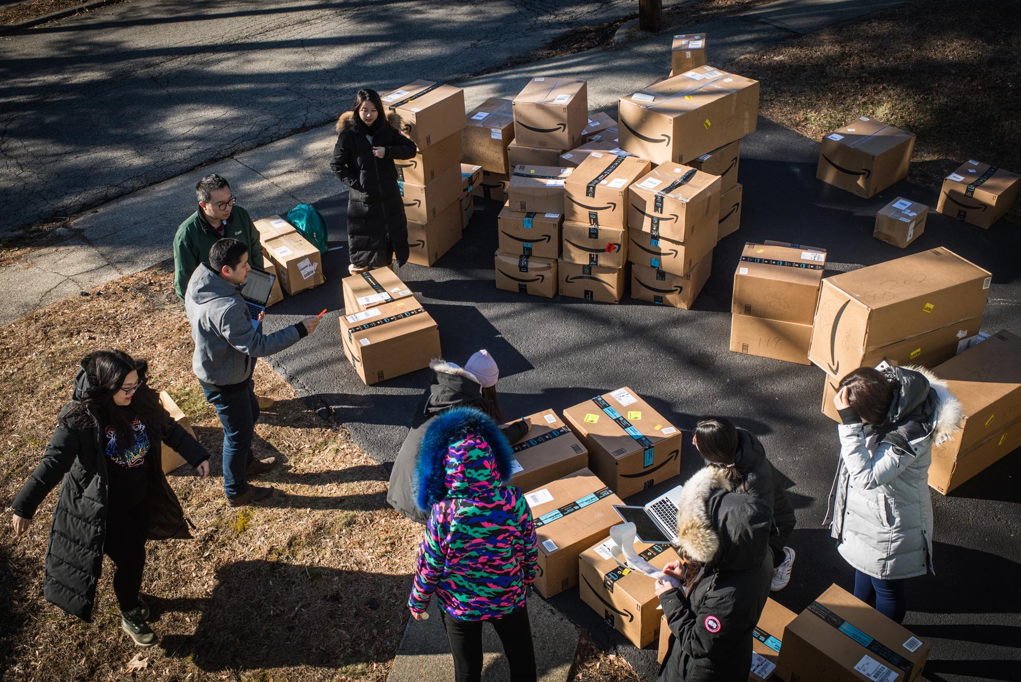 A photo of Shishong Chen, a law student from China, and other students organizing boxes that will be shipped to China.