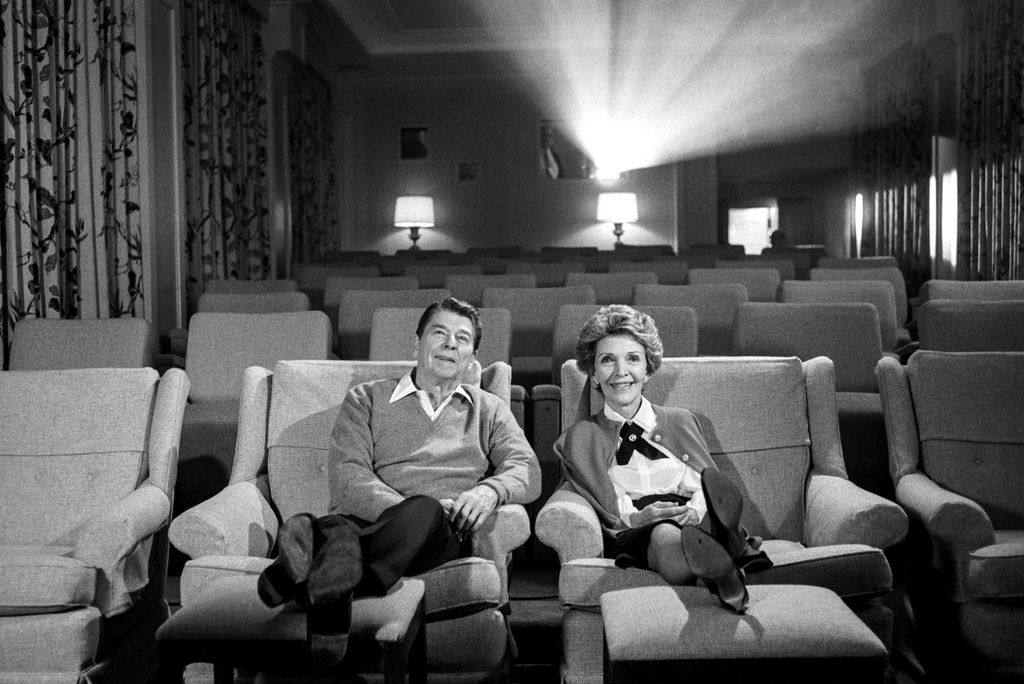 The Reagans watch a movie during a taping for a television special with Barbara Walters in the Family Theater of the White House.