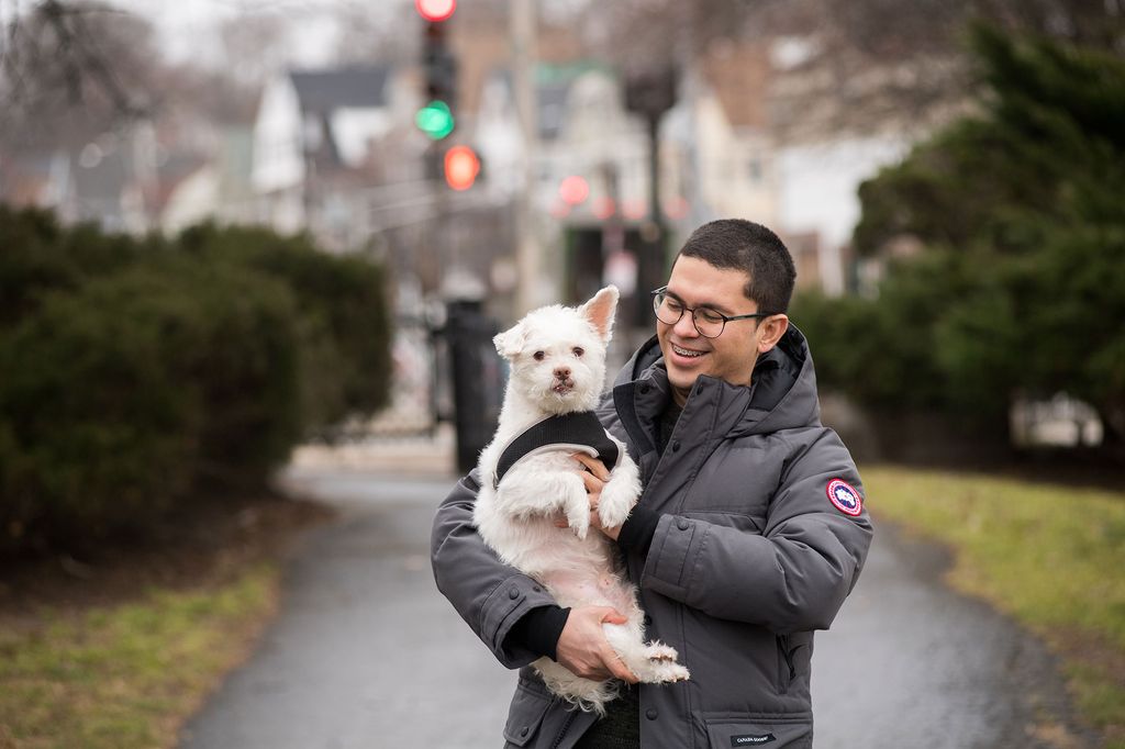 Selvin Marroquin carries his dog Scruffy