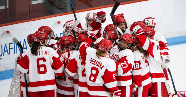 A photo of the BU women's hockey team celebrating a win.