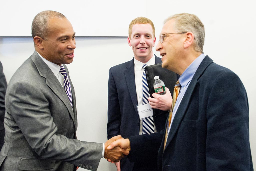 Photo of Professor Azer Bestavros shaking hands with Governor Deval Patrick as Holyoke mayor, Alex Morse looks on at the Massachusetts Green High Performance Computing Center in Holyoke, MA in April 2014.