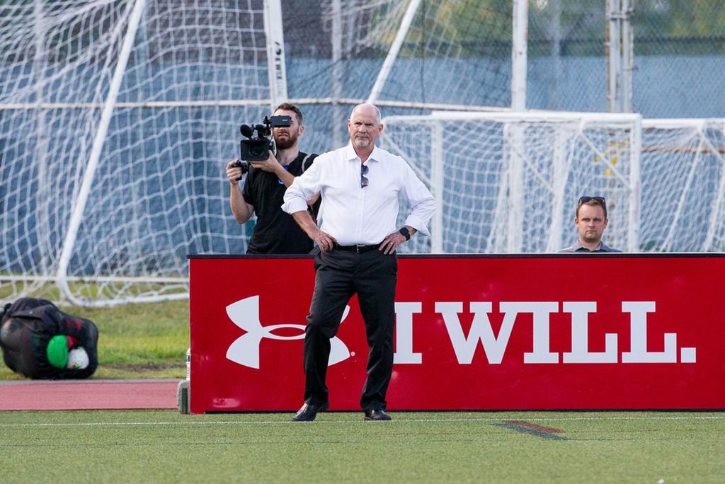 A photo of Neil Roberts standing on the sideline