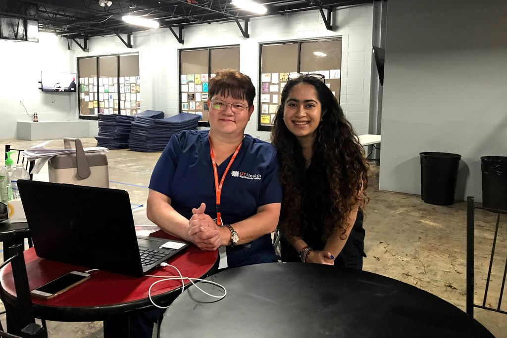A photo of a student and nurse posed together