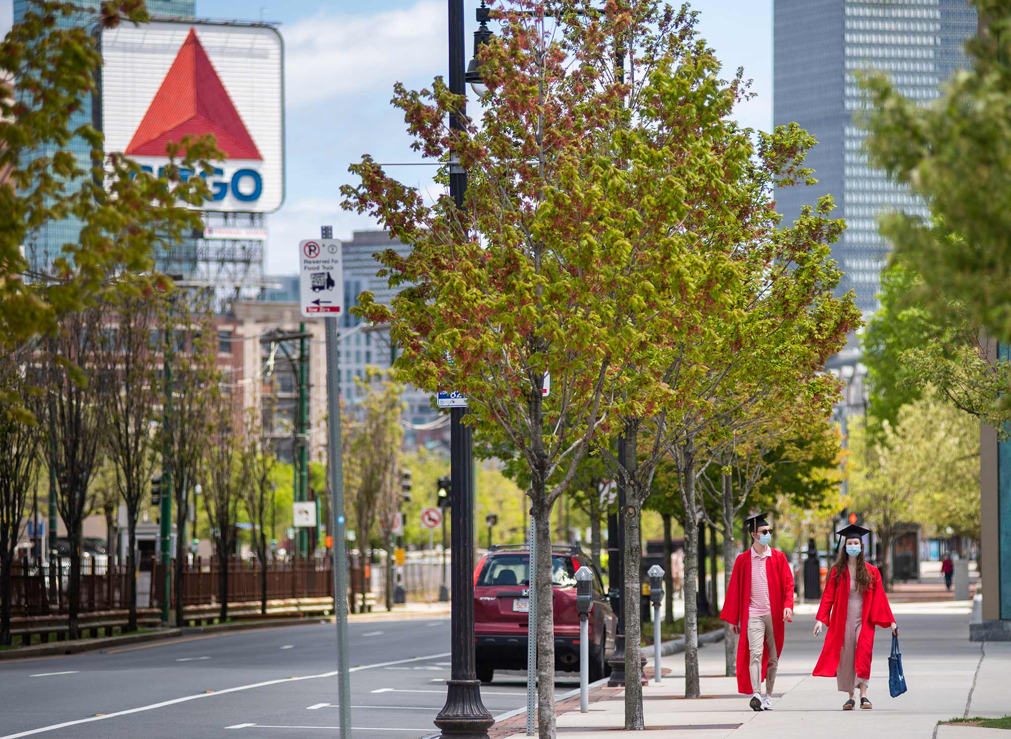 Joe Besser (QST’20) and Michelle Goltsman (COM’20) take a walk down a street near campus on May 16, 2020. The Citgo sign is seen on the left in distance, as well as the green line tracks.