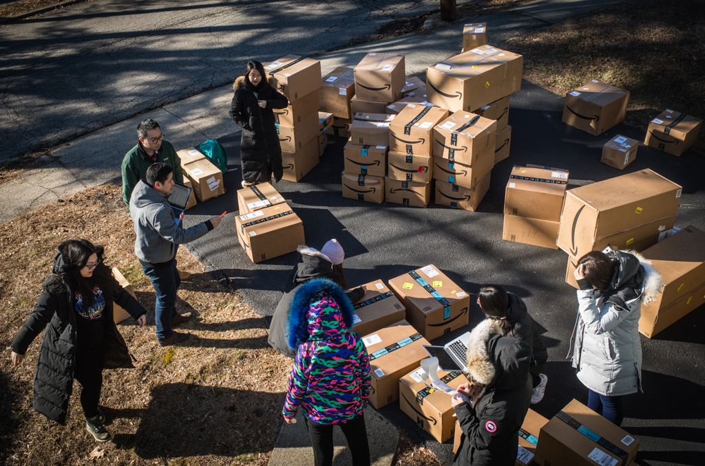Photo of students organizing boxes to ship to China.