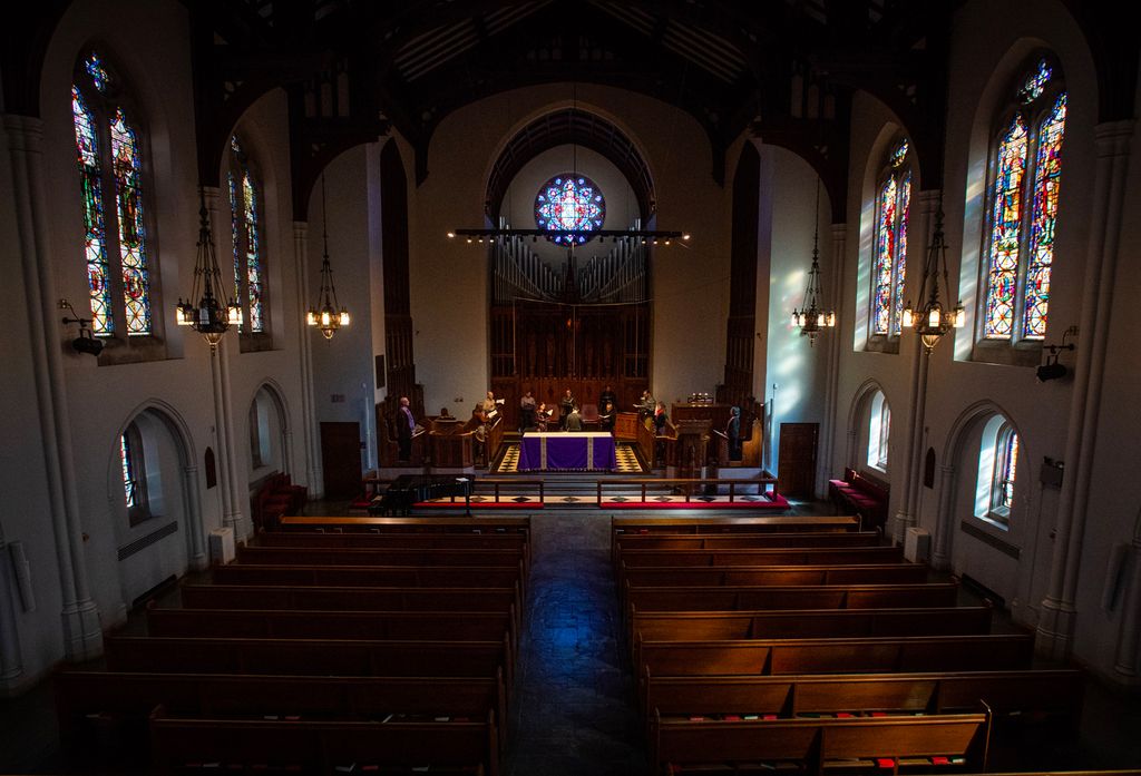 Photo of the Rev. Robert A. Hill preaching to an empty church.