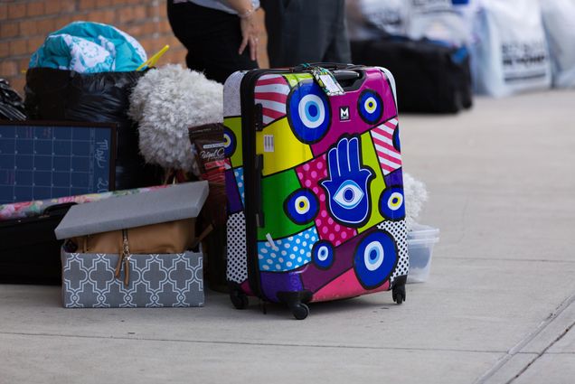 A photo of a student with their suitcase on BU move in day