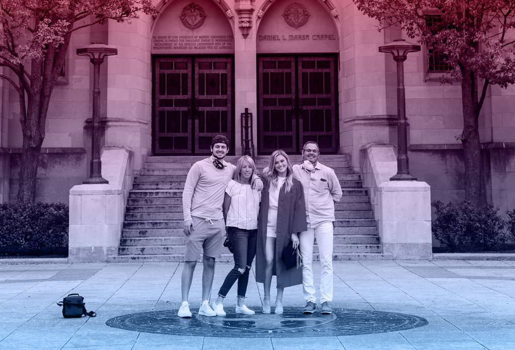 Photo of a student and family stepping on the seal on the day that would've been Boston University Commencement.