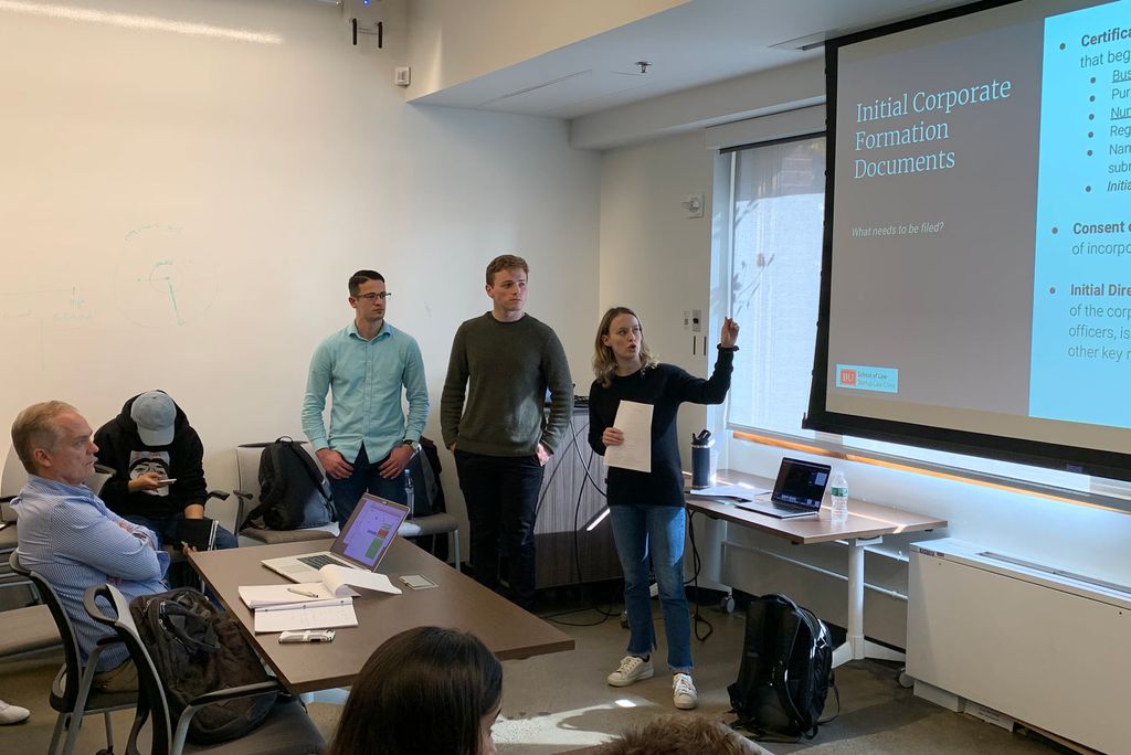 创业法律诊所 members (from left) Harry Brown (LAW’20), James Christopher (LAW’20), and Tyler Isaman (LAW’20), as Isaman outlines to an audience of MIT students what it takes to form a corporation.