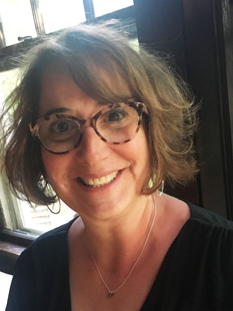 Portrait of Rodi Rosensweig (’87), senior principal media relations strategist for the Humane Society of the United States. She wears turtle glasses and smiles.