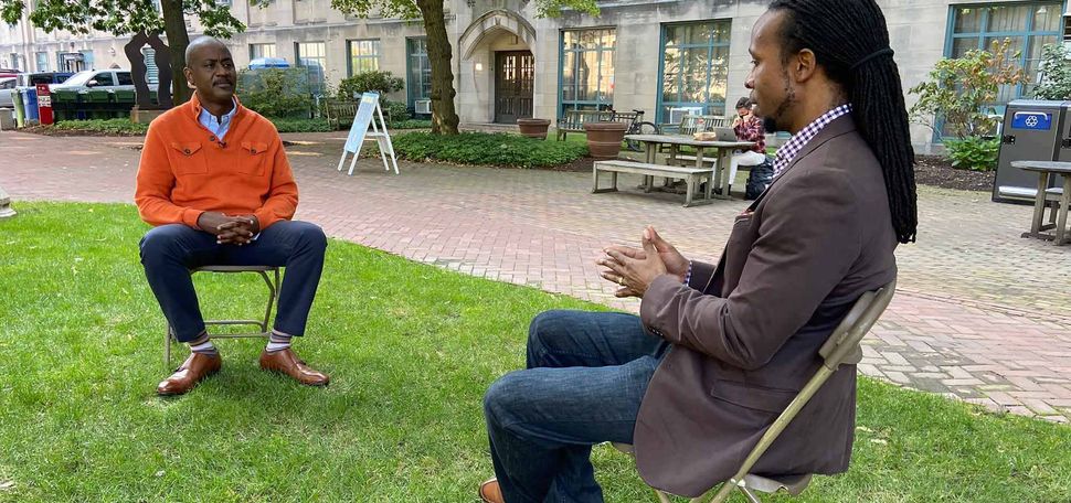 Otis Rolley III, Senior Vice President, U.S. Equity and Economic Opportunity Initiative at The Rockefeller Foundation, and Ibram X. Kendi, Director and Founder of the Boston University Center for Antiracist Research, in a discussion outdoors at Boston University. Photo courtesy of The Rockefeller Foundation