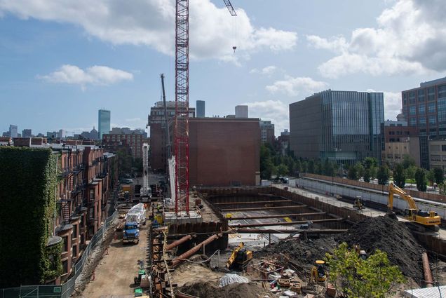Photo of construction at Data Services Center, including the addition of a massive crane September 13. The sky is bright and has white fluffy clouds.