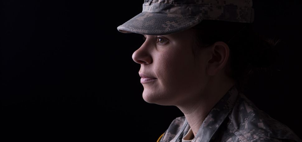 A photo of a solider in front of a black background