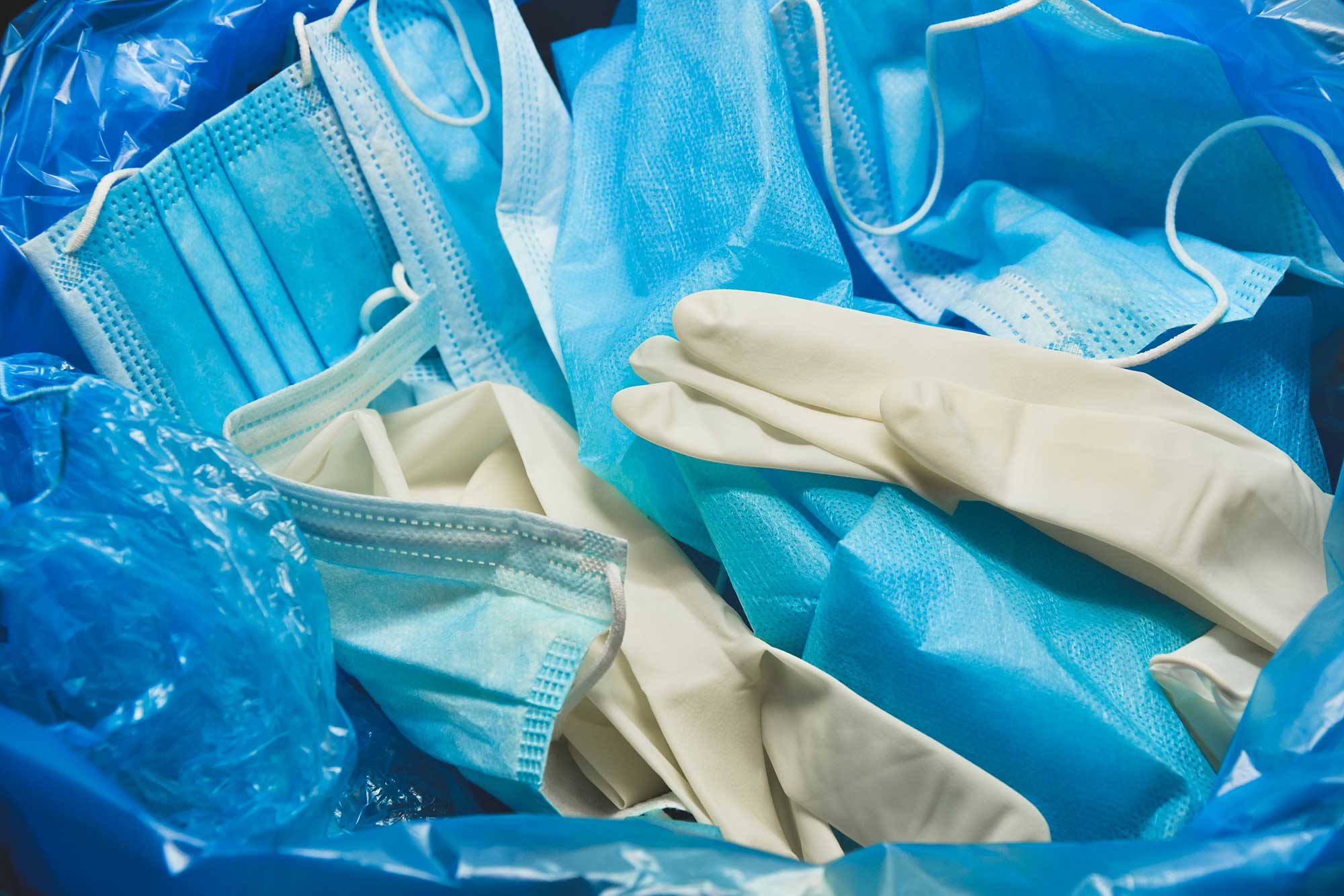 PPE discarded in medical waste bin