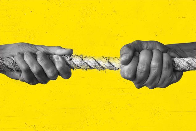 two hands pulling on a rope