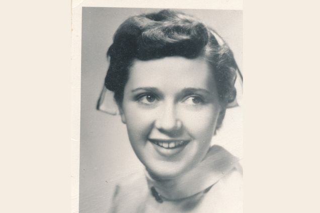 Black and white photo of a young Jo Anne Swart, a RN/nurse practitioner whose area of expertise was death and dying. She died of COVID-19 on December 8 at the age of 87. In the portrait, she smiles wide and looks to her left.
