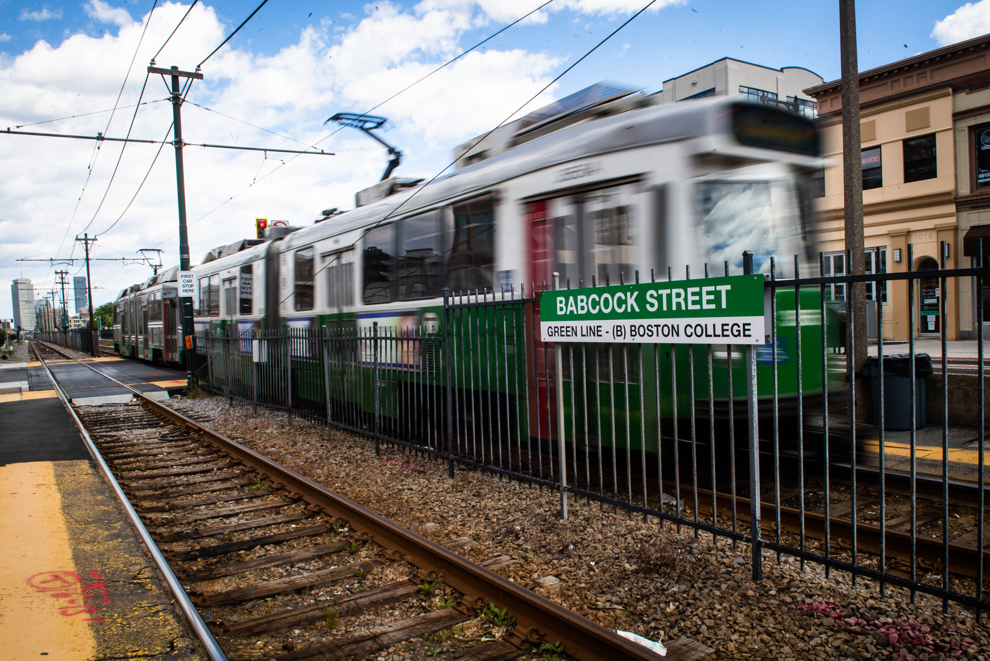 A photo of the MBTA green line running down Comm Ave.