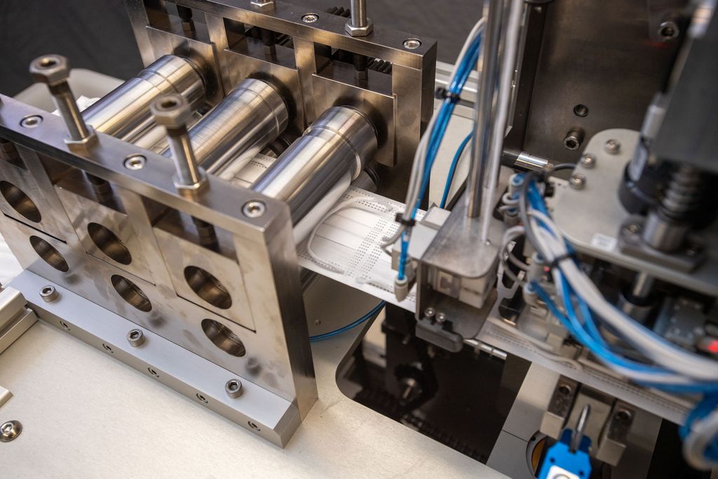 A photo of the mask making machine producing masks