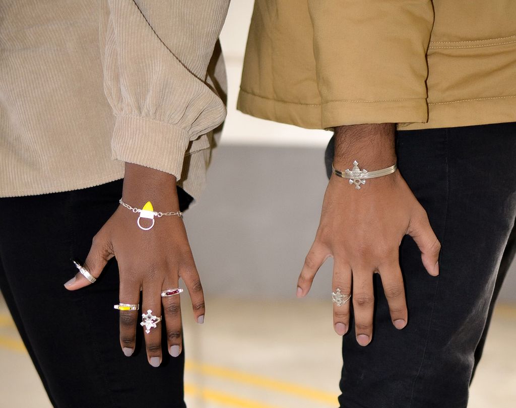 A photo of models showing off Tchidite rings and bracelets.