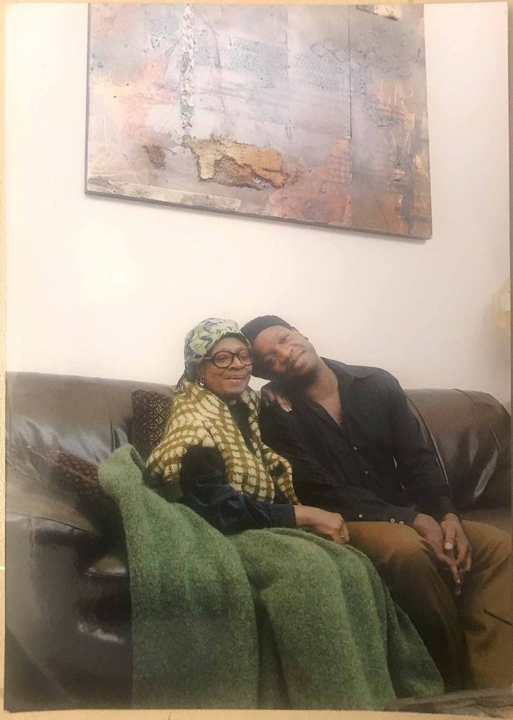 Louis Chude-Sokei sitting on a couch with his mother