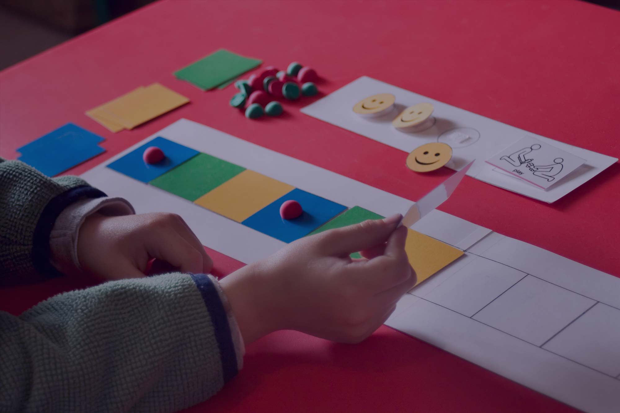 A autistic child works on a cognitive exercise for pattern perception.