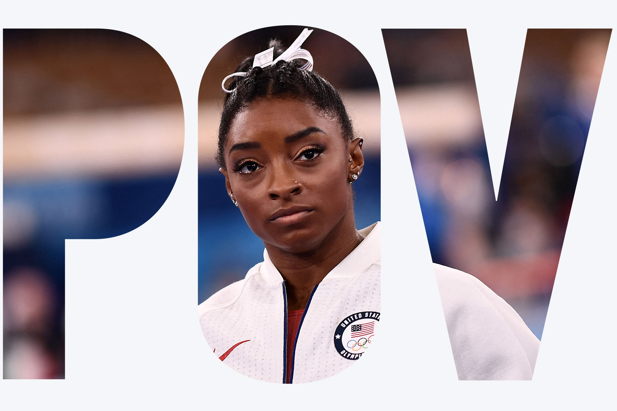 Photo of USA's Simone Biles, in her white USA sweatsuit, looking a little somber as she waits for the final results of the artistic gymnastics women's team final during the Tokyo 2020 Olympic Games at the Ariake Gymnastics Centre in Tokyo on July 27, 2021. Overlay reads "POV"