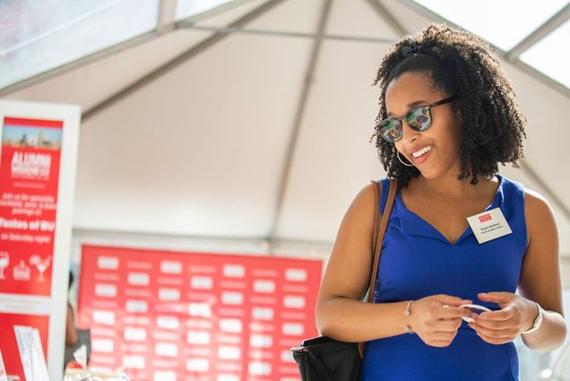 A BU Alum smiles as she checks in on campus