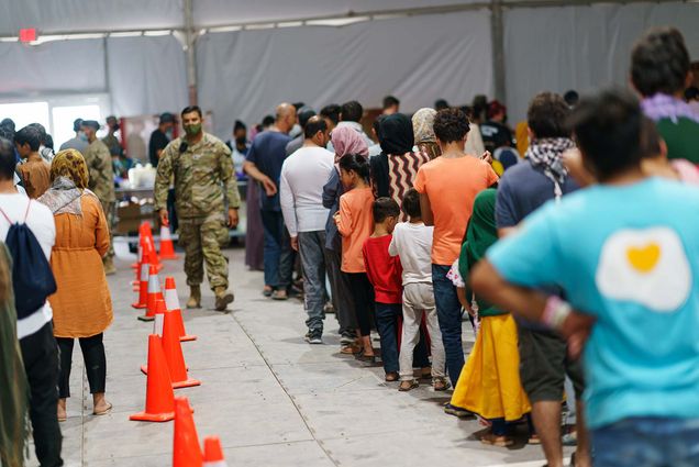 Afghan refugees line up for food in a dining hall at Fort Bliss' Doña Ana Village, in New Mexico, where they are being housed.