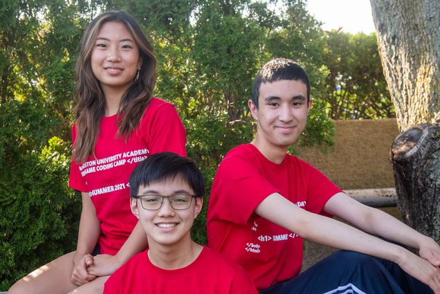 Photos of Joie Liu (from left), Alvin Lu, and Gabriel Romualdo, wearing read shirts and smiling as they sit on the edge of a park bench. Trees are seen behind them.