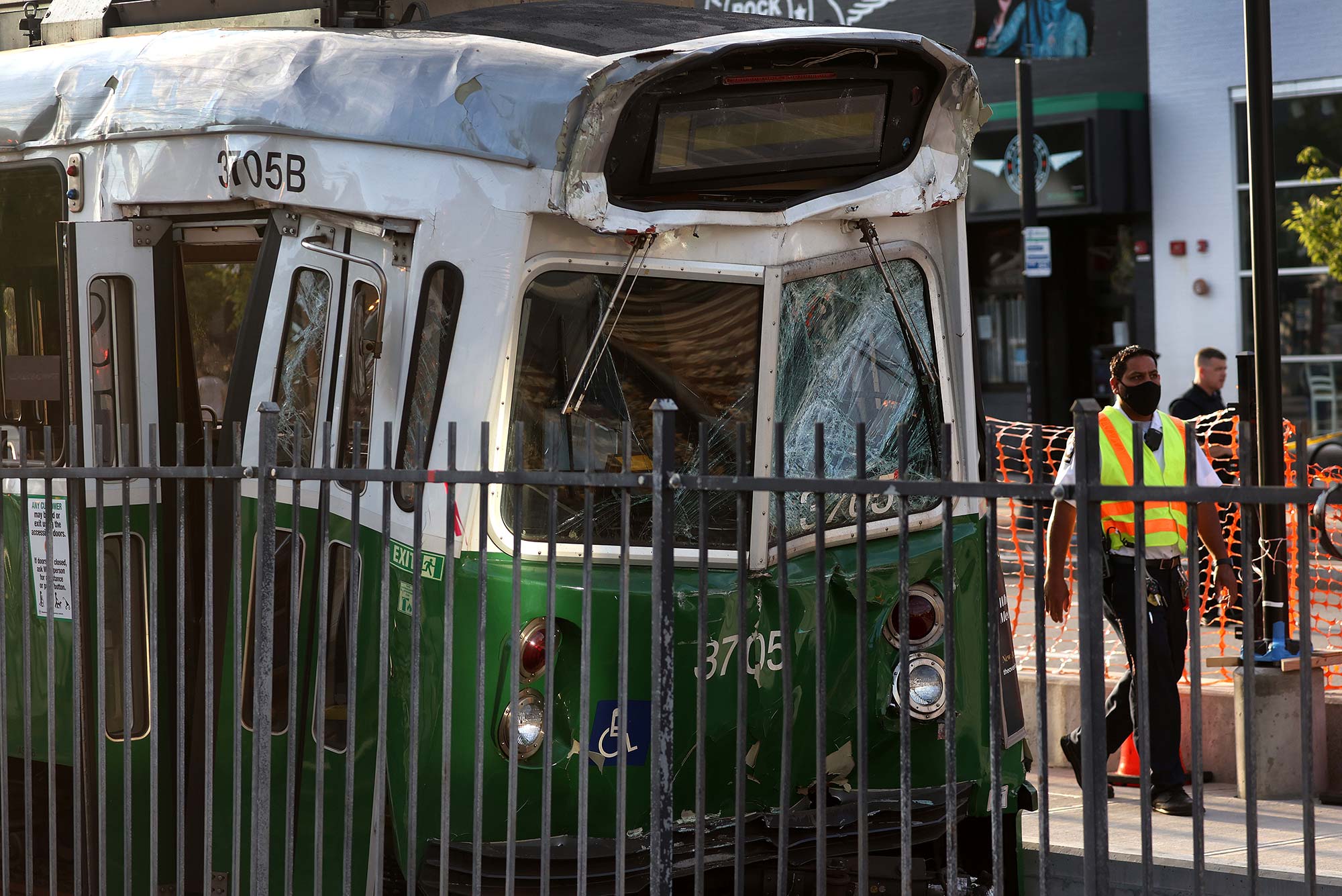 Photo taken July 30 of the scene of a crash between two Green line T trains near 971 Commonwealth Ave in Boston. The front of the green line car is smushed in, the glass is broken and the car lights are off.