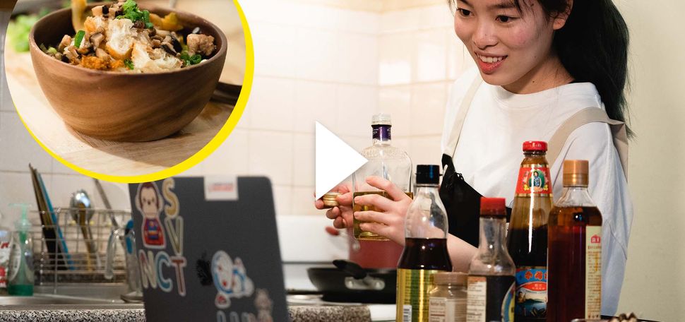 Photo of Luyi Chen (Sargent’22), looking at her laptop and smiling, as she prepares the dish sticky rice, a photo of which is seen in a small circle at the left top of the image; the dish has a yellow circle as an outline. Chen holds a bottle of oil in her hands and other ingredients she's using are seen on the island table in front of her. The dish is served in a wooden bowl and has scallions and meat floss on top. Play button is overlaid.