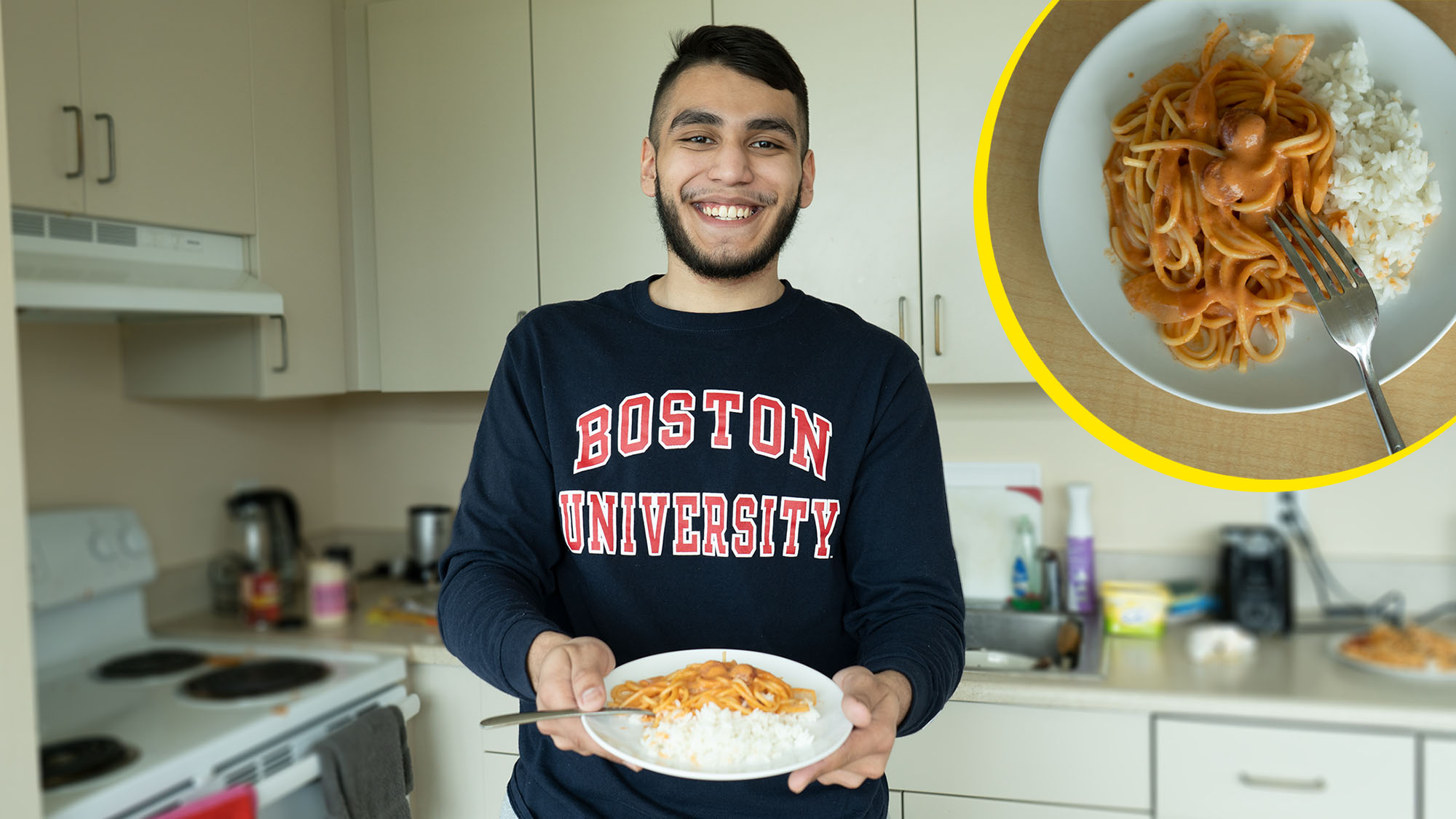 Photo of Riaz Butt-Garcia (CAS’22), wearing a blue BU sweatshirt with 'Boston University' written in red, holding a plate of Honduran spaghetti with white rice on the side. He stands in his kitchen, which is blurred, and a closeup photo of the spaghetti is overlaid in the top left with a yellow outline.