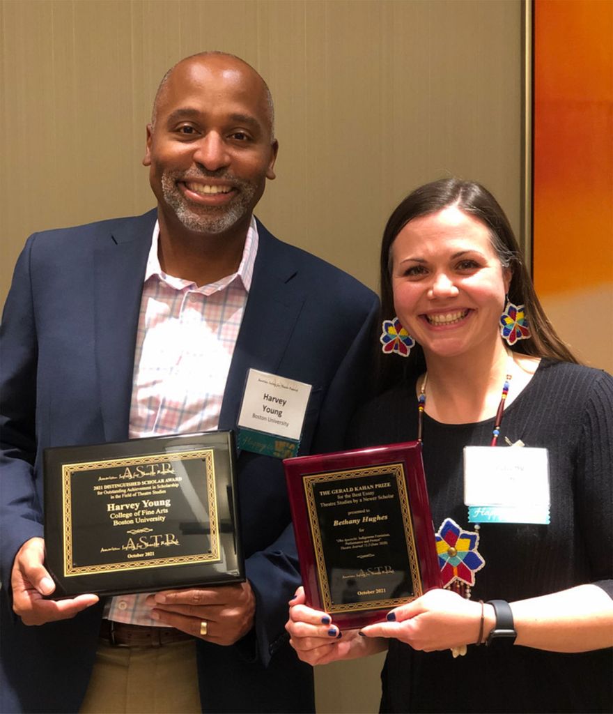 Photo of Harvey Young with his plaque at the recent American Society for Theatre Research conference with best-article award winner Bethany Hughes, a University of Michigan faculty member, to his left. They both smile and wear formal attire.
